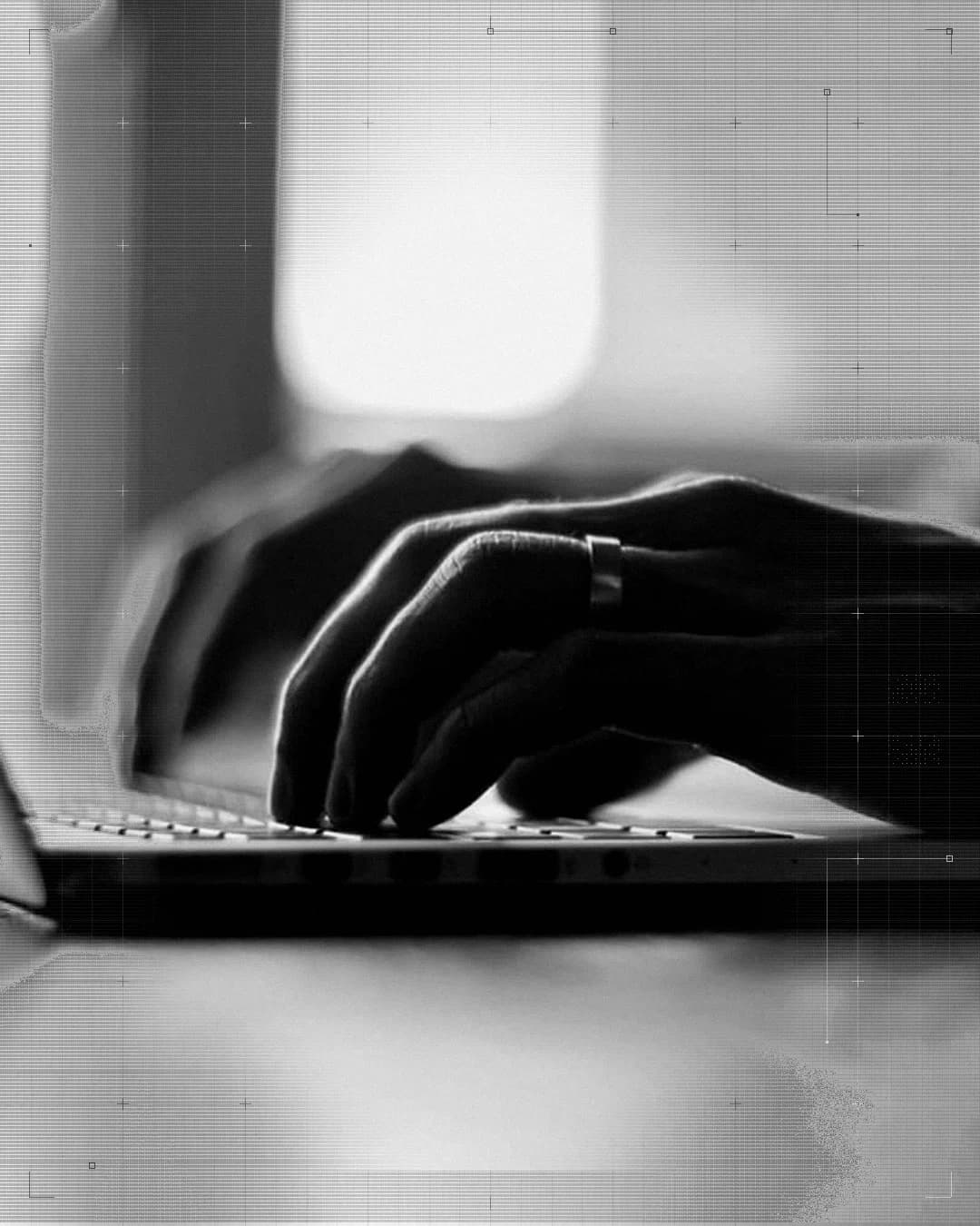 Hands typing at a laptop.