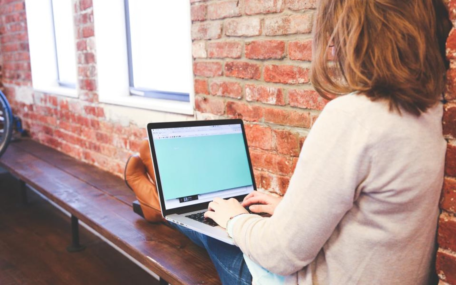 A business owner at a laptop, working through what customers have said about her.